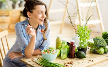 Happy woman eating a salad