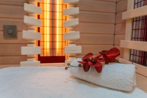 Rolled towel with flowers on top in a sauna cabin